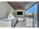 The covered outdoor kitchen features a built-in grill and bar, perfect for entertaining guests with room to relax at 8528 Baltimore Heights Ct, Las Vegas, NV 89113
