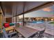 Inviting outdoor space featuring a covered patio, dining area, pool, and built-in bar for ultimate relaxation and entertaining at 8528 Baltimore Heights Ct, Las Vegas, NV 89113