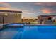 Enjoy a swimming pool, spa, fire pit and outdoor kitchen area in this luxury backyard at 8528 Baltimore Heights Ct, Las Vegas, NV 89113