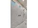 Shower showcasing tiled walls, a rain shower head, and frameless glass door at 8528 Baltimore Heights Ct, Las Vegas, NV 89113