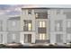 Modern townhome with multi-level balconies and stone accents on the exterior elevation at 8683 Luxuriant Ave # Lot 26, Las Vegas, NV 89148