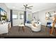 Inviting living area with a contemporary sofa, a ceiling fan, and lots of natural light at 8683 Luxuriant Ave # Lot 26, Las Vegas, NV 89148