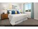 Serene main bedroom with a plush bed, calming colors, and a window overlooking a green space at 8683 Luxuriant Ave # Lot 26, Las Vegas, NV 89148