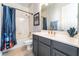 Well-lit bathroom with a shower-tub combo, grey cabinets, and gold hardware at 8824 Killians Greens Dr, Las Vegas, NV 89131
