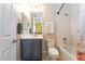 Bathroom featuring grey vanity, a toilet and tub with shower combination at 8824 Killians Greens Dr, Las Vegas, NV 89131