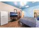 Unique bedroom features statement wall, herringbone floors, modern fixtures, and ample natural light at 8824 Killians Greens Dr, Las Vegas, NV 89131