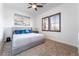 Comfortable bedroom with a plush bed, ceiling fan, and large windows at 8824 Killians Greens Dr, Las Vegas, NV 89131