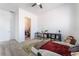 Bright bedroom with carpet, ceiling fan, shutters, closet and desk at 8824 Killians Greens Dr, Las Vegas, NV 89131