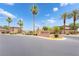 Stone sign for Mountain Palms community with mature palm trees against a sunny sky at 8824 Killians Greens Dr, Las Vegas, NV 89131