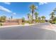 Welcoming entrance to the Palms community, showcasing beautiful landscaping and a clear, sunny sky at 8824 Killians Greens Dr, Las Vegas, NV 89131