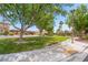 Picturesque community park with lush green grass, mature trees, and walking paths in a residential area at 8824 Killians Greens Dr, Las Vegas, NV 89131
