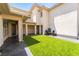 Rear courtyard featuring artificial turf and covered patio at 8824 Killians Greens Dr, Las Vegas, NV 89131