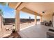 Covered patio with neutral decor, a ceiling fan and drought-resistant landscaping at 8824 Killians Greens Dr, Las Vegas, NV 89131