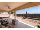 View of outdoor covered patio with ceiling fan, desert landscaping and mountain views at 8824 Killians Greens Dr, Las Vegas, NV 89131