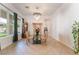 Formal dining area features tile flooring and a modern chandelier at 8824 Killians Greens Dr, Las Vegas, NV 89131