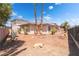 Low-maintenance backyard with rock landscaping, mature palm trees, and multi-story home in background at 8824 Killians Greens Dr, Las Vegas, NV 89131