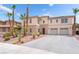 Front exterior view of a home showing desert landscaping with cactus and palm trees, and an attached two-car garage at 8824 Killians Greens Dr, Las Vegas, NV 89131
