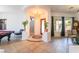 Open foyer with tile flooring, chandelier, staircase, and view to other rooms at 8824 Killians Greens Dr, Las Vegas, NV 89131