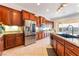 Well-lit kitchen with stainless steel appliances, granite countertops, and ample cabinet space at 8824 Killians Greens Dr, Las Vegas, NV 89131
