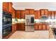 Modern kitchen featuring stainless steel appliances and wood cabinetry at 8824 Killians Greens Dr, Las Vegas, NV 89131