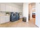 Spacious laundry room with modern washer and dryer and ample storage at 8824 Killians Greens Dr, Las Vegas, NV 89131
