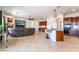 Open-concept living room featuring tile floors, a fireplace, and a built-in kitchen bar at 8824 Killians Greens Dr, Las Vegas, NV 89131