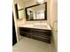 Modern bathroom vanity with floating sink and large mirror at 8925 W Flamingo Rd # 319, Las Vegas, NV 89147