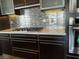 Close-up of kitchen featuring sleek countertops, stainless steel appliances, and mosaic backsplash at 8925 W Flamingo Rd # 319, Las Vegas, NV 89147