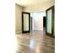 Open space with hardwood floors and view of hall through modern glass paneled doors at 8925 W Flamingo Rd # 319, Las Vegas, NV 89147