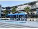 Modern building with blue canopies and pool side seating at 8925 W Flamingo Rd # 319, Las Vegas, NV 89147