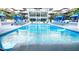 Community pool featuring lounge chairs, umbrellas and the building in the background at 8925 W Flamingo Rd # 319, Las Vegas, NV 89147
