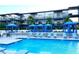 Community pool featuring lounge chairs, umbrellas, and the building in the background at 8925 W Flamingo Rd # 319, Las Vegas, NV 89147