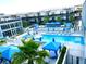 Aerial view of a pool area featuring lounge chairs, umbrellas, cabanas, and the building in the background at 8925 W Flamingo Rd # 319, Las Vegas, NV 89147
