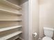A half bathroom featuring a toilet, floating shelves, and modern fixtures at 9050 W Tropicana Ave # 1017, Las Vegas, NV 89147