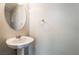 Clean powder room featuring a pedestal sink with stylish mirror, optimizing a small space at 9050 W Tropicana Ave # 1017, Las Vegas, NV 89147