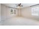 Spacious bedroom with plush carpeting, a ceiling fan, and large windows offering natural light at 9050 W Tropicana Ave # 1017, Las Vegas, NV 89147