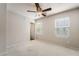A spacious bedroom featuring a fan, plush carpet, and bright natural light from two windows at 9050 W Tropicana Ave # 1017, Las Vegas, NV 89147