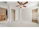 A cozy bedroom with plush carpet and several doors and hallways for easy access at 9050 W Tropicana Ave # 1017, Las Vegas, NV 89147