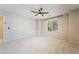 Comfortable bedroom with plush carpet, ceiling fan, and a bright window with views of the surroundings at 9050 W Tropicana Ave # 1017, Las Vegas, NV 89147