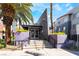 Contemporary building entrance with palm trees, purple planters and accessible ramp at 9050 W Tropicana Ave # 1017, Las Vegas, NV 89147