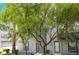 Modern gray two-story home with a well-manicured front yard and trees lining the walkway at 9050 W Tropicana Ave # 1017, Las Vegas, NV 89147