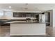 Bright, open kitchen with stainless steel appliances, granite counters, and a large center island at 9050 W Tropicana Ave # 1017, Las Vegas, NV 89147