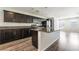 Well-lit open kitchen with granite countertops, stainless steel appliances, and wood flooring at 9050 W Tropicana Ave # 1017, Las Vegas, NV 89147