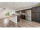 Spacious kitchen features stainless steel appliances, dark cabinets, and an island with granite countertops at 9050 W Tropicana Ave # 1017, Las Vegas, NV 89147