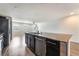 Modern kitchen featuring a granite island and stainless steel appliances, flowing into a spacious living area at 9050 W Tropicana Ave # 1017, Las Vegas, NV 89147