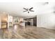 Open-concept kitchen and living area with stainless steel appliances and wood flooring at 9050 W Tropicana Ave # 1017, Las Vegas, NV 89147