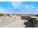 Expansive roof deck with sleek wall, offering views of the neighborhood and mountains in the distance at 9050 W Tropicana Ave # 1017, Las Vegas, NV 89147