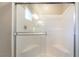 Modern bathroom shower with a glass enclosure, built-in seats, and clean white tiling at 9050 W Tropicana Ave # 1017, Las Vegas, NV 89147