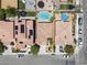 Aerial view from above of two backyards with pools and trampolines and two homes with solar panels at 9074 Iron Cactus Ave, Las Vegas, NV 89148