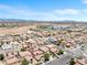 A residential neighborhood with many homes, desert views and hills beyond, and a school nearby at 9074 Iron Cactus Ave, Las Vegas, NV 89148